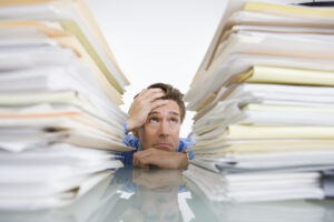 Businessman Overwhelmed with Paperwork